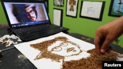 Artist Abdelrahman al-Habrouk creates a portrait of the actor Johnny Depp with tobacco in Alexandria, Egypt, Aug. 10, 2017. 