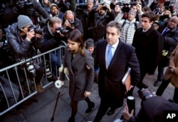 FILE - Michael Cohen, center, President Donald Trump's former lawyer, accompanied by his children Samantha, left, and Jake, right, arrives at federal court for his sentencing in New York, Dec. 12, 2018.