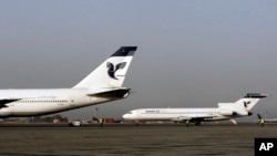 In this March 2, 2008 file photo, two passenger planes of Iran's national air carrier, Iran Air, are parked at the Mehrabad Airport in Tehran, Iran.