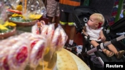 FILE - A young child looks at the array of candy displayed inside a toy store in New York, July 15, 2015.