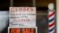 "For Sale By Owner" and "Closed Due to Virus" signs are displayed in the window of Images On Mack in Grosse Pointe Woods, Mich., April 2, 2020.