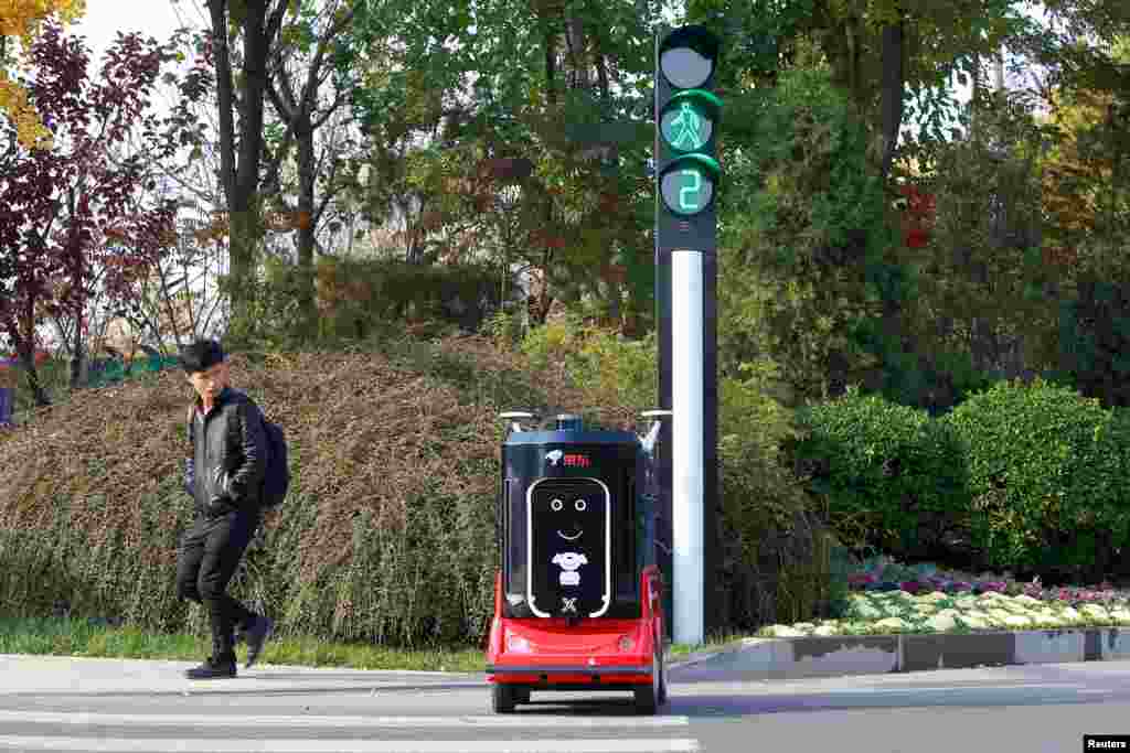 A JD.com driverless delivery robot crosses the road in Tianjin, China, Nov. 12, 2018.