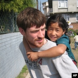 Conor Grennan with Anga, one of the young children he came to know at the Little Princes Children's Home in Nepal.