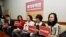 FILE - In this photo taken March 24, 2017, Lee Ching-yu, third from right holds up a photo of her missing husband and Taiwanese pro-democracy activist Lee Ming-che during a press conference with other representatives of non-governmental organizations calling for help to find his whereabouts in Taipei, Taiwan.