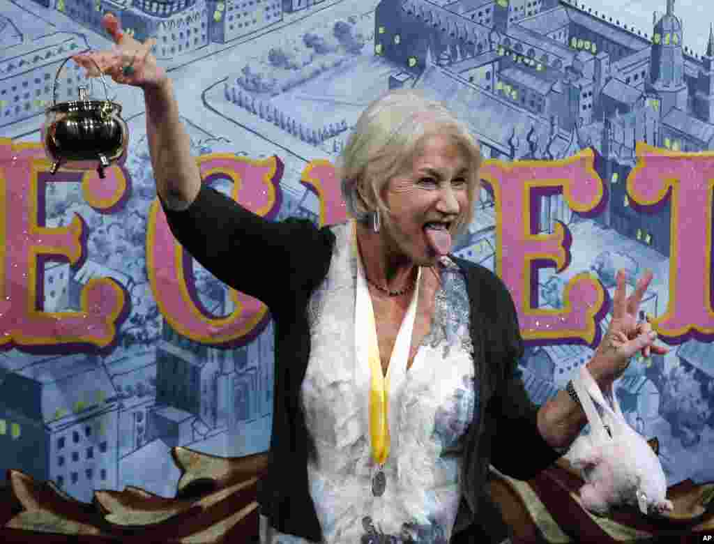 Actress Helen Mirren holds the Hasty Pudding Pot and sticks her tongue out as she is honorned as Hasty Pudding Theatricals 2014 Woman of the Year at Harvard University in Cambridge, Massachusetts, Jan. 30, 2014.