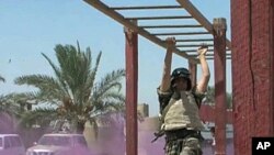 An Iraqi soldier performs a drill at a military base near Baghdad under the supervision of US advisers, who provide guidance, surveillance equipment and air support, Aug 2010