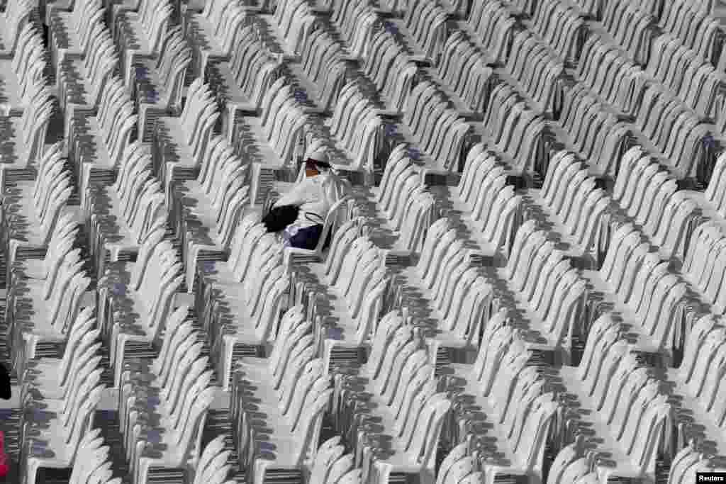 A faithful waits for a holly Mass by Pope Francis at Simon Bolivar park in Bogota, Colombia.