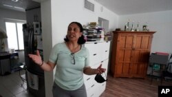 Cristina Livingston recounts the problems she has had in her apartment including a leaking ceiling and mold, June 18, 2021, at her home in Bay Harbor Islands, Fla. 