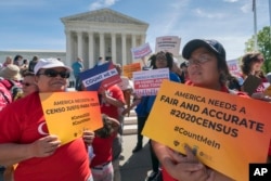 FILE - Immigration activists rally outside the Supreme Court as the justices hear arguments over the Trump administration's plan to ask about citizenship on the 2020 census, in Washington, April 23, 2019.