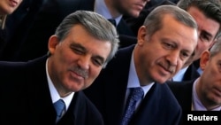 Turkish President Abdullah Gul (L) and Prime Minister Tayyip Erdogan (C) arrive at the opening ceremony of a new line of the Ankara Metro, in Ankara, Feb. 12, 2014.