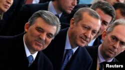 Turkish President Abdullah Gul (L) and Prime Minister Tayyip Erdogan (C) arrive at the opening ceremony of a new line of the Ankara Metro, in Ankara, Feb. 12, 2014.