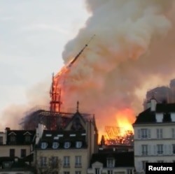 The Notre Dame Cathedral spire collapses during a fire in Paris, France April 15, 2019 in this image taken from social media video. (Instagram/@nicolas_marang)