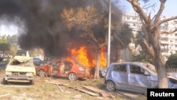 Vehicles burn after an explosion in central Damascus. (February 21, 2013)