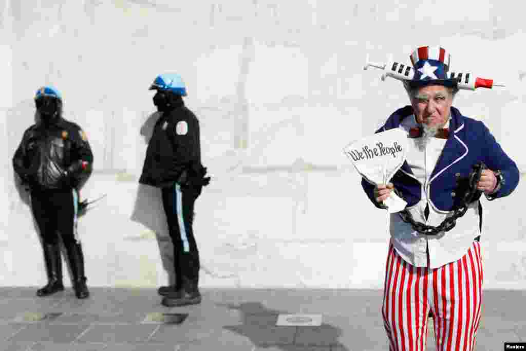 A man wearing a costume poses next to police officers at the Lincoln Memorial during the anti-vaccine mandate march in Washington, D.C..