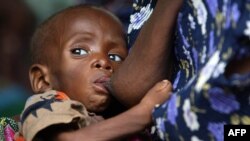 A Malawian child, suffering from HIV, breast-feeds at the Zomba Nutritional and Rehabilitation Unit, 60 kms south of Blantyre, October 14, 2005 file photo. 