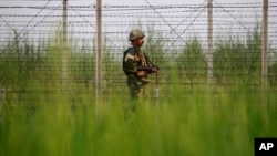 An Indian Border Security Force soldier patrols near the India-Pakistan international border area at Gakhrial boder post in Akhnoor sector, about 48 kilometers from Jammu, India, Oct. 1, 2016. 