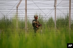 An Indian Border Security Force soldier patrols near the India-Pakistan international border area at Gakhrial boder post in Akhnoor sector, about 48 kilometers from Jammu, India, Oct. 1, 2016.