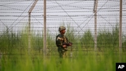 An Indian Border Security Force soldier patrols near the India-Pakistan international border area at Gakhrial boder post in Akhnoor sector, about 48 kilometers from Jammu, Oct. 1, 2016. 