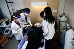 Nurses take part in the coronavirus disease vaccination mock drill at a first aid facility of the COVID-19 vaccination center in Seoul, Feb. 9, 2021.