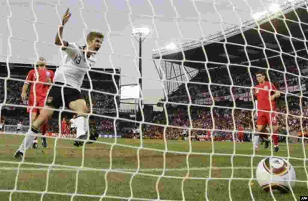 Germany's Thomas Mueller, second left, celebrates scoring his side's forth goal during the World Cup round of 16 soccer match between Germany and England at Free State Stadium in Bloemfontein, South Africa, Sunday, June 27, 2010. (AP Photo/Gero Breloer)