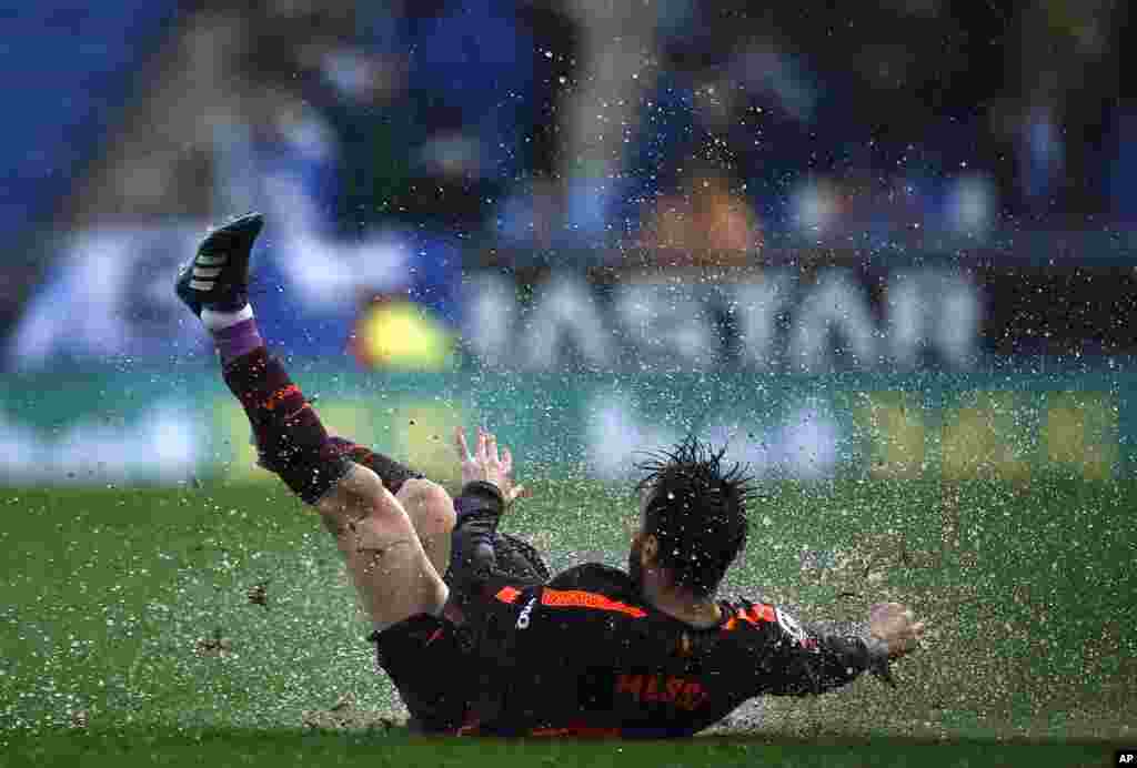 FC Barcelona&#39;s Lionel Messi falls during the Spanish La Liga soccer match between Espanyol and FC Barcelona at RCDE stadium in Cornella Llobregat, Spain.