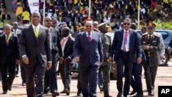 President Omar al-Bashir of Sudan, center, arrives for the inauguration ceremony of Uganda's long-time president Yoweri Museveni in the capital Kampala, May 12, 2016.