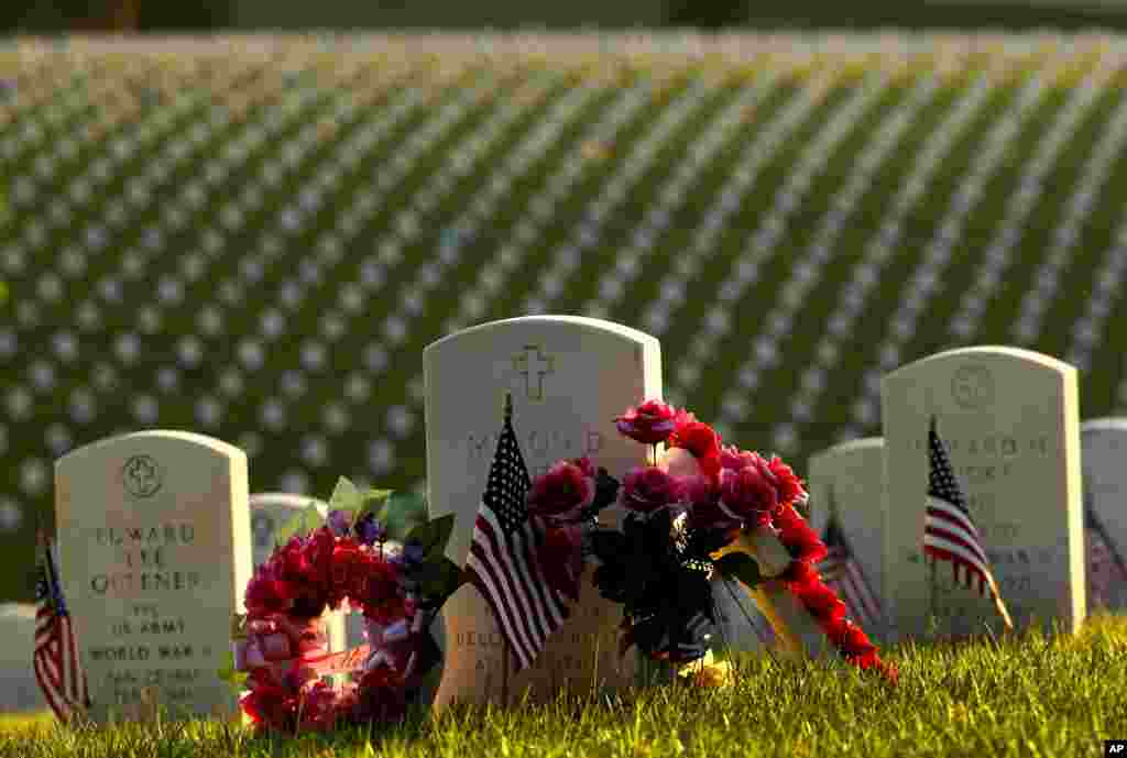 A tombstone is decorated at Levenworth National Cemetery on the eve of Memorial Day, May 27, 2018, in Leavenworth, Kansas.