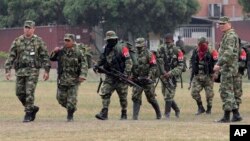 Soldados escoltan a varios guerrilleros del ELN que el año pasado depusieron las armas. 