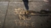 Messages written in a parking lot protest the shooting of Michael Brown in Ferguson, Missouri, Aug. 15, 2014.