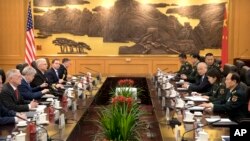 U.S. Defense Secretary Jim Mattis (L) listens as China's Defense Minister Wei Fenghe (R) speaks during a meeting at the Bayi Building in Beijing, June 27, 2018. 