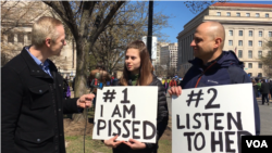 Indiana high school student Sofia Balcius holds a sign with her father, Minda, while attending the March for Our Lives gun control demonstration on March 24, 2018, in Washington D.C. (Dorry Gundy/VOA)