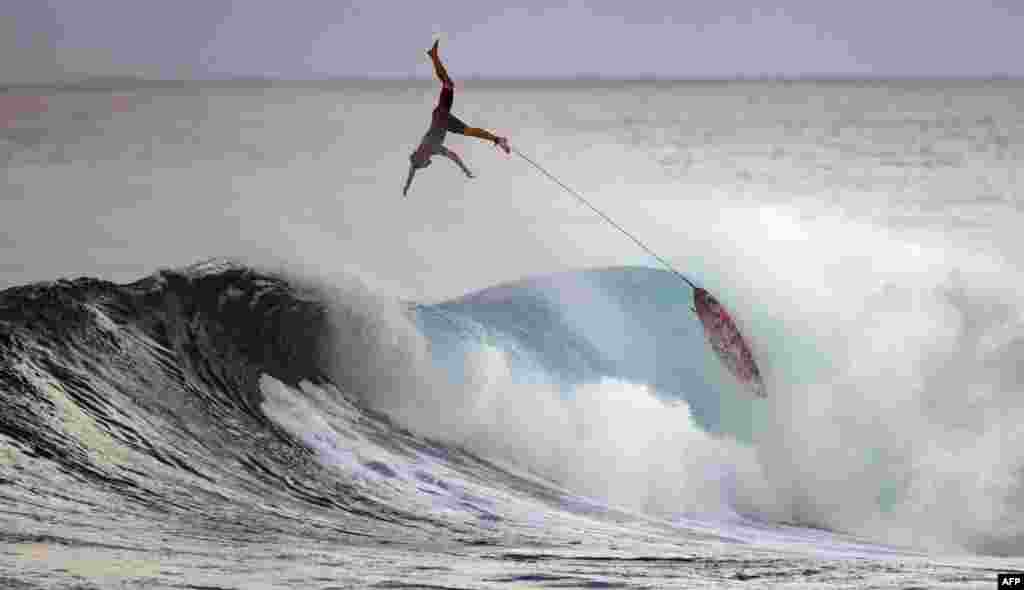 Surfer Nathan Florence wipes out during practice at Sunset Beach in Pupukea, Oahu, Hawaii, Dec. 29, 2020.