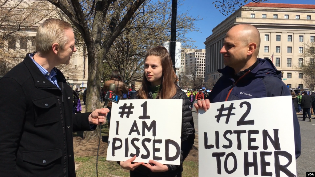 Indiana high school student Sofia Balcius holds a sign with her father, Minda, while attending the March for Our Lives gun control demonstration on March 24, 2018, in Washington D.C. (Dorry Gundy/VOA)