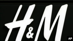 FILE - The logo of H & M, a Swedish multinational clothing-retail company, is pictured on the Champs Elysees Avenue in Paris, France, Sept. 20, 2017. 