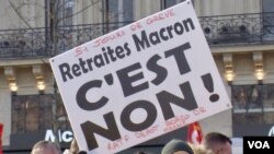 A sign denouncing President Emmanuel Macron's pension reforms notes that the protest movement marked its 51st day, Jan. 24, 2020, in Paris. (Lisa Bryant/VOA)