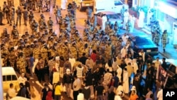 Anti-riot police stand-off with protesters in the Gulf coast town of Awwamiya, Saudi Arabia, March 3, 2011