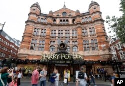 FILE - The Palace Theatre in London advertises, July 28, 2016, the new Harry Potter play: "Harry Potter and the Cursed Child," a two-part stage drama that picks up 19 years after the novels ended.
