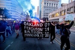 FILE - Demonstrators march in Oakland, Calif., May 29, 2020.