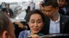 Myanmar Migrants in Thailand Rush Police, Greet Suu Kyi  