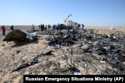 Russian and Egyptian experts work at the crash site of a Russian passenger plane bound for St. Petersburg in Russia that crashed in Hassana, Egypt's Sinai Peninsula, Nov. 2, 2015.