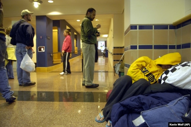 A student sleeps in the hallway of Hall Memorial Building on the campus of Gallaudet University on Friday, October 6, 2006, in Washington, DC.
