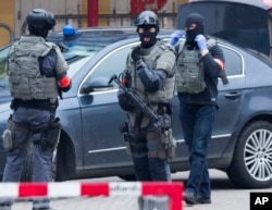 FILE - Special operations police secure an area during a police raid in the Molenbeek neighbourhood of Brussels, Belgium on March 18, 2016.