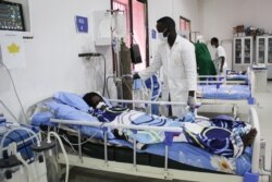 A doctor cares a patient who is infected with the COVID-19 in the Intensive Care Unit at Martini hospital in Mogadishu, Somalia, July 29, 2020.