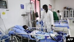 FILE - A doctor cares a patient who is infected with the COVID-19 in the Intensive Care Unit at Martini hospital in Mogadishu, Somalia, July 29, 2020.