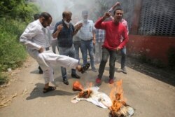 Janata Dal (United) activists burn an effigy representing China during a protest against the Chinese government in Jammu, India, Friday, June 19, 2020.