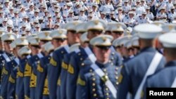 FILE - Military members watch graduating Cadets as they march together for a commencement ceremony at the United States Military Academy in West Point, New York, U.S., May 25, 2019.