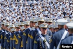 FILE - Military members watch graduating Cadets as they march together for a commencement ceremony at the United States Military Academy in West Point, New York, U.S., May 25, 2019.