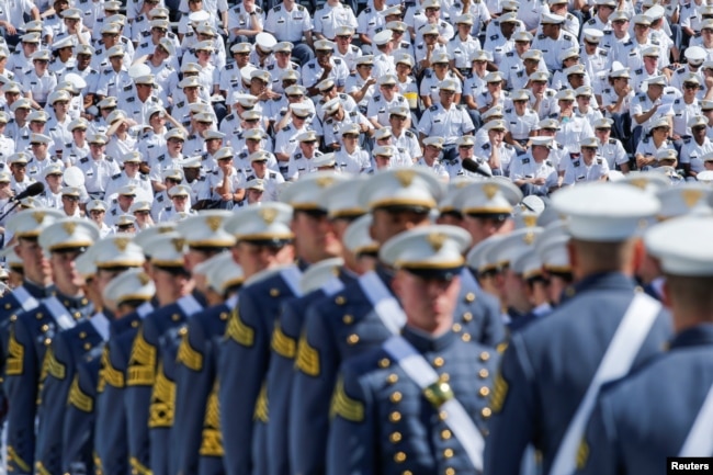 FILE - Military members watch graduating Cadets as they march together for a commencement ceremony at the United States Military Academy in West Point, New York, U.S., May 25, 2019.