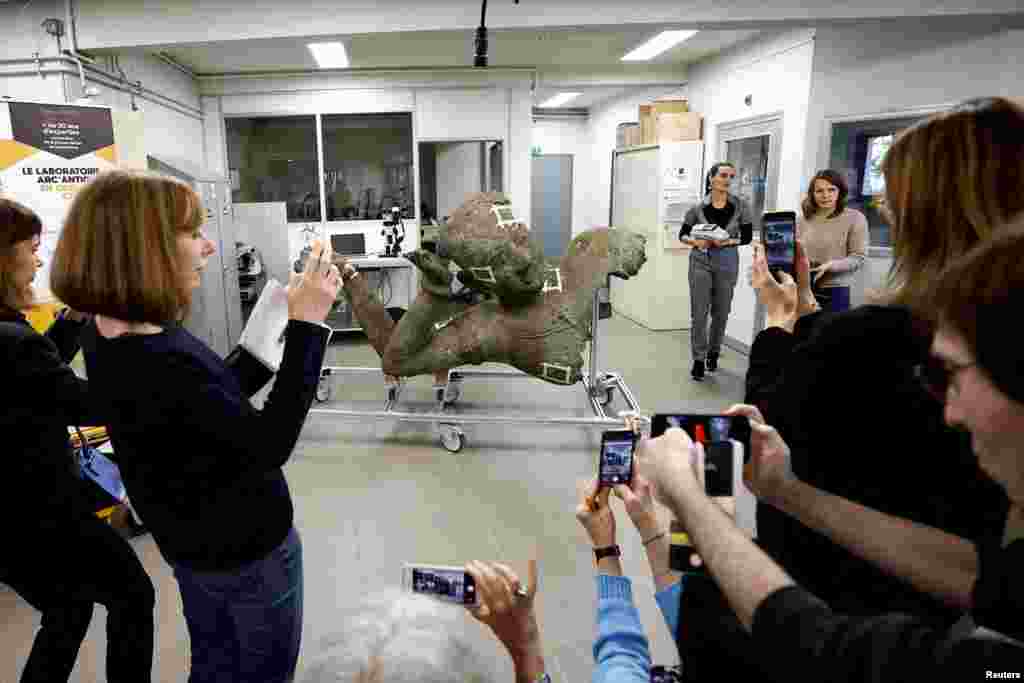 Journalists take pictures of the Reclining Vishnu, known as the &quot;Mona Lisa of Cambodia&quot; or the &quot;Venus de Milo of Cambodia,&quot; from the West Mebon temple in Angkor during a press event for statue&#39;s restoration by the Center for Research and Restoration in French Museums&nbsp;at the Arc&#39;Antique laboratory in Nantes, France.