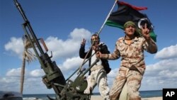 FILE - Libyan militia members from towns throughout the country's west parade through Tripoli, Feb. 2012.
